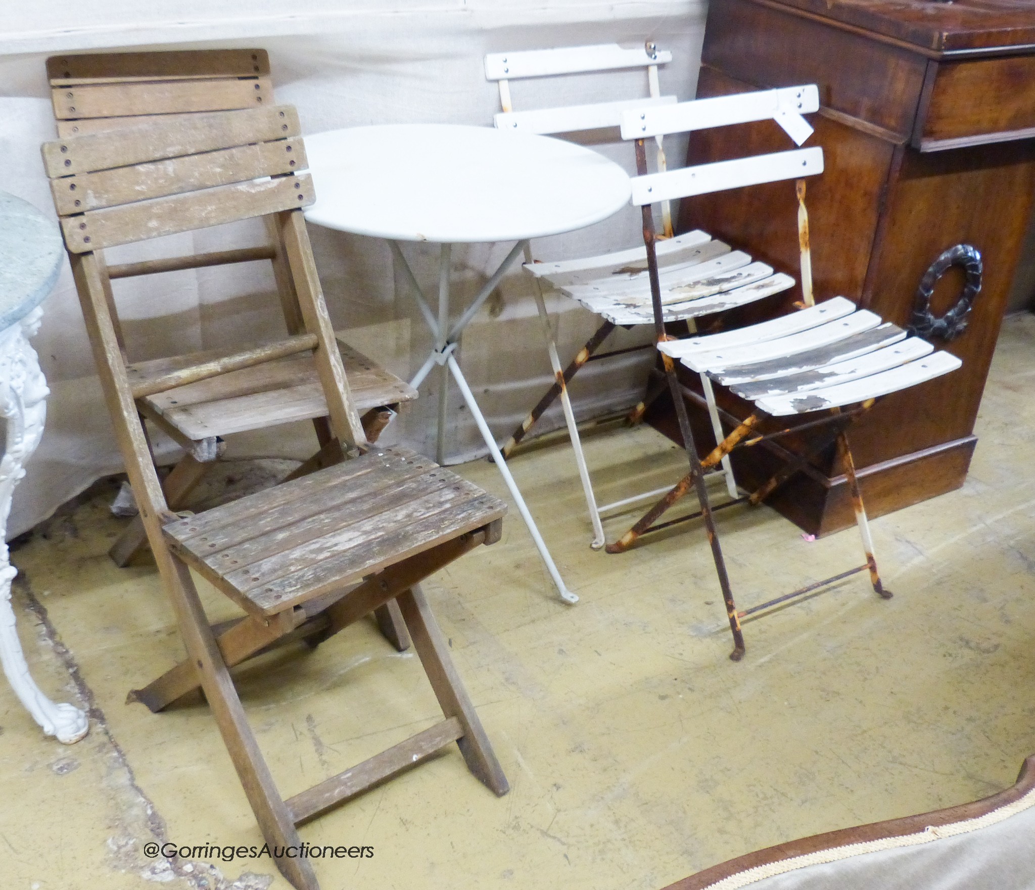 A circular metal garden table, D-59cm, together with two pairs of folding chairs.